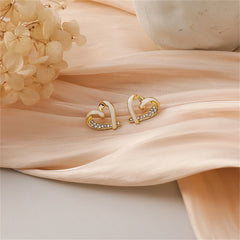 Chic heart-shaped stud earrings in gold and white enamel, showcasing 18K gold plating and radiant cubic zirconia for elegance.