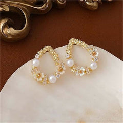 Dazzling 18K gold-plated floral earrings with teardrop shape, embellished with pearls and cubic zirconia accents.