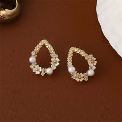 Beautiful gold-plated flower earrings featuring teardrop design with pearls and cubic zirconia for added sparkle.