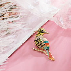 Elegant bird brooch showcasing vibrant hues, crafted in 18K gold plating and adorned with brilliant cubic zirconia.
