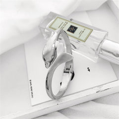 Silver-plated dolphin hinged bangle, elegantly designed to capture the essence of marine life in a stylish accessory.