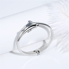 Silver-plated hinged bangle with a dolphin motif, combining elegance and a love for marine life in a fashionable piece.