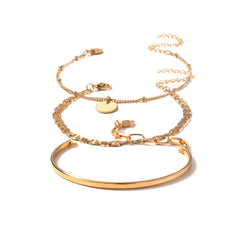 A stunning set of three gold bracelets adorned with a chic disc charm, ideal for elevating your accessory game.
