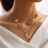 Elegant 18K gold-plated layered necklace featuring delicate butterfly charms, perfect for adding a touch of whimsy to any outfit.