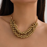 Elegant 18K gold-plated beaded necklace featuring two strands of shimmering gold beads for a stunning statement look.