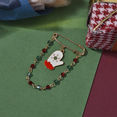 A colorful red and green mitten pin adorned with a gold chain, a delightful accessory for your Christmas celebrations.