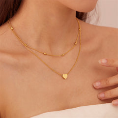Elegant 18K gold-plated choker necklace featuring a charming heart pendant, perfect for adding a touch of love to any outfit.