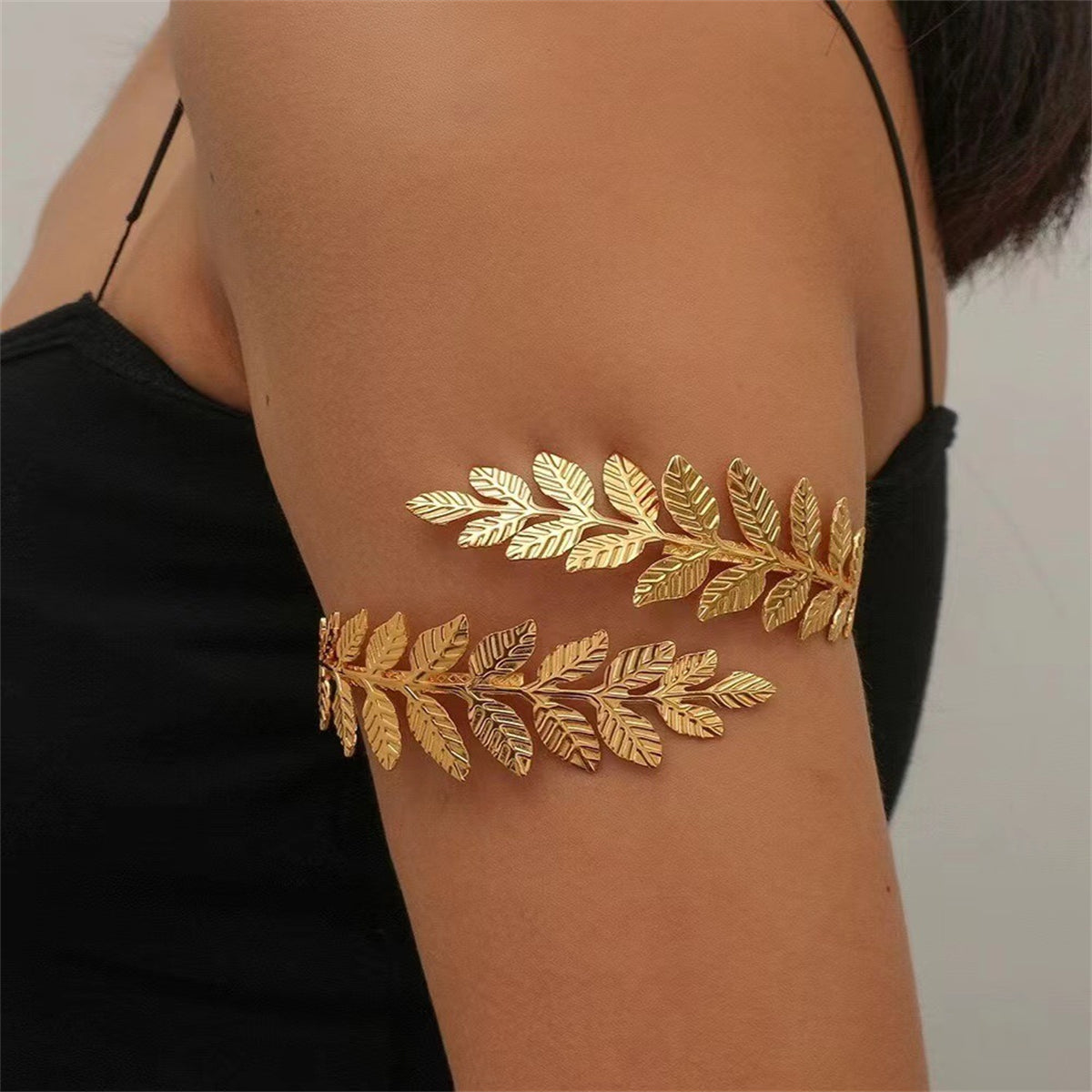 Elegant gold leaf featuring an 18K gold-plated branch arm cuff, perfect for adding a touch of luxury to any outfit.