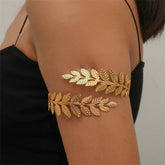 Elegant gold leaf featuring an 18K gold-plated branch arm cuff, perfect for adding a touch of luxury to any outfit.