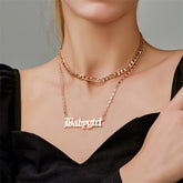 Elegant 18K gold-plated layered bar necklace featuring the name 'Baby Girl' in stunning gold lettering.