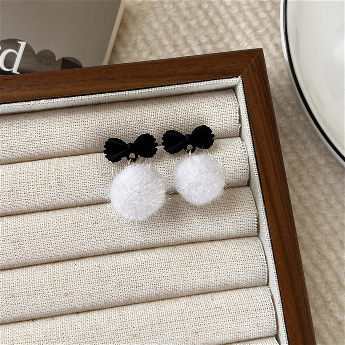 Black Enamel and White Pom-Pom Bow Drop Earrings, drop earrings for women, vintage-inspired design, detail close-up