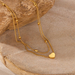 Beautiful gold chain necklace adorned with a heart charm, showcasing 18K gold-plated beads for a chic and romantic look.