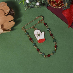 Bright red and green mitten brooch with a gold chain, an elegant accessory to celebrate the Christmas season in style.