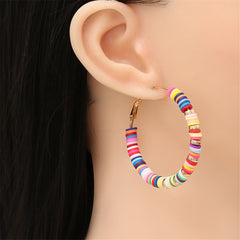 Stylish hoop earrings in wood and metal, showcasing multicolor polymer clay and 18K gold-plated beads.