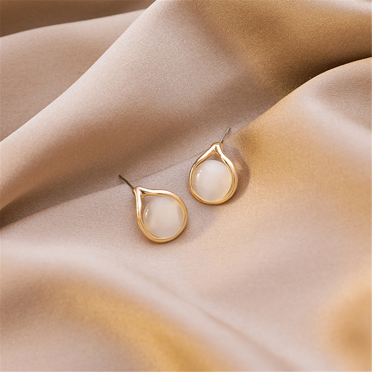 Stunning 18K gold-plated earrings showcasing peach cat's eye, adding a touch of elegance to your look.