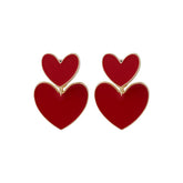 Eye-catching red heart-shaped ear jackets, adorned with 18K gold plating for a fashionable touch.