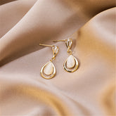 Stunning 18K gold-plated drop earrings adorned with white stones and clear crystals, perfect for any elegant occasion.
