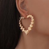 Stunning 18K gold-plated hoop earrings shaped like hearts, perfect for adding a touch of romance to any outfit.
