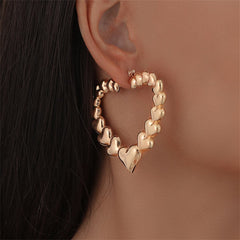 Stunning 18K gold-plated hoop earrings shaped like hearts, perfect for adding a touch of romance to any outfit.