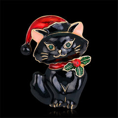 A stylish black cat brooch with a Santa hat, exquisitely made in 18K gold-plated and embellished with cubic zirconia.