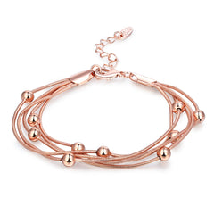 Stylish 18K rose gold-plated bracelet with four strands of shimmering beads, ideal for a chic accessory look.