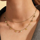 Elegant 18K gold-plated layered necklace featuring four delicate butterfly charms on a shimmering chain.