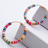 Vibrant wooden and metal hoop earrings adorned with polymer clay and 18K gold-plated multicolor beads.