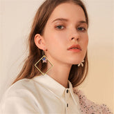 Stunning 18K gold-plated earrings shaped like the American flag, featuring a star, ideal for patriotic occasions.