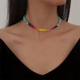 Multicolored beaded bracelet featuring a gold chain, showcasing vibrant hues and intricate design.