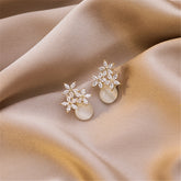 Exquisite stud earrings with a gold-plated base, featuring floral motifs in cateye and clear cubic zirconia.
