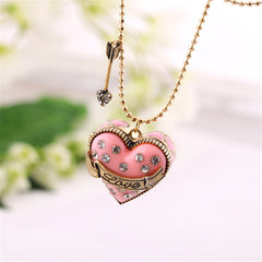 Pink heart-shaped pendant with a diamond arrow, featuring a cubic zirconia and 18K gold-plated 'Love' locket design.