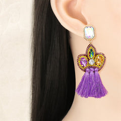 Elegant purple tassel earrings embellished with sparkling crystals and beads, perfect for adding flair to any outfit.
