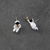 White astronaut stud earrings with an oil drip design, 18K gold-plated, perfect for kids.