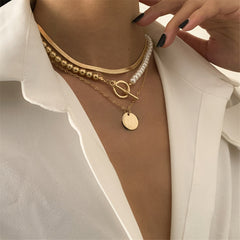 Elegant layered necklace set with a pearl and gold coin, showcasing a stylish 18K gold-plated toggle design.
