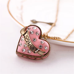 Heart-shaped pink pendant with a diamond arrow, made of cubic zirconia and 18K gold-plated, designed as a 'Love' locket.