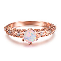 Exquisite rose gold solitaire ring set with a radiant opal and surrounded by brilliant cubic zirconia accents.