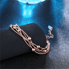 Elegant 18K rose gold-plated bracelet adorned with four strands of beautiful beads, perfect for any occasion.