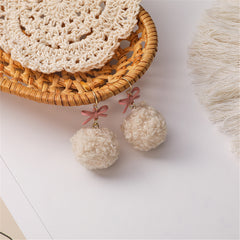 Chic 18K gold-plated earrings with soft white pom poms and a delightful pink bow, perfect for any outfit.