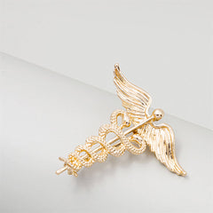Stunning gold caduceus brooch with angel wings and snake design, representing the essence of medical care and compassion.