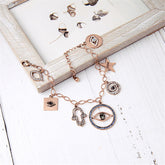 An elegant charm bracelet showcasing an evil eye, star, and lips, embellished with cubic zirconia and 18K gold.