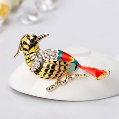 A luxurious bird brooch, beautifully colored and finished in 18K gold plating, embellished with shimmering cubic zirconia.