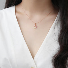 Beautiful rose gold necklace with pink floral accents and white stones, featuring a cubic zirconia and pearl pendant.