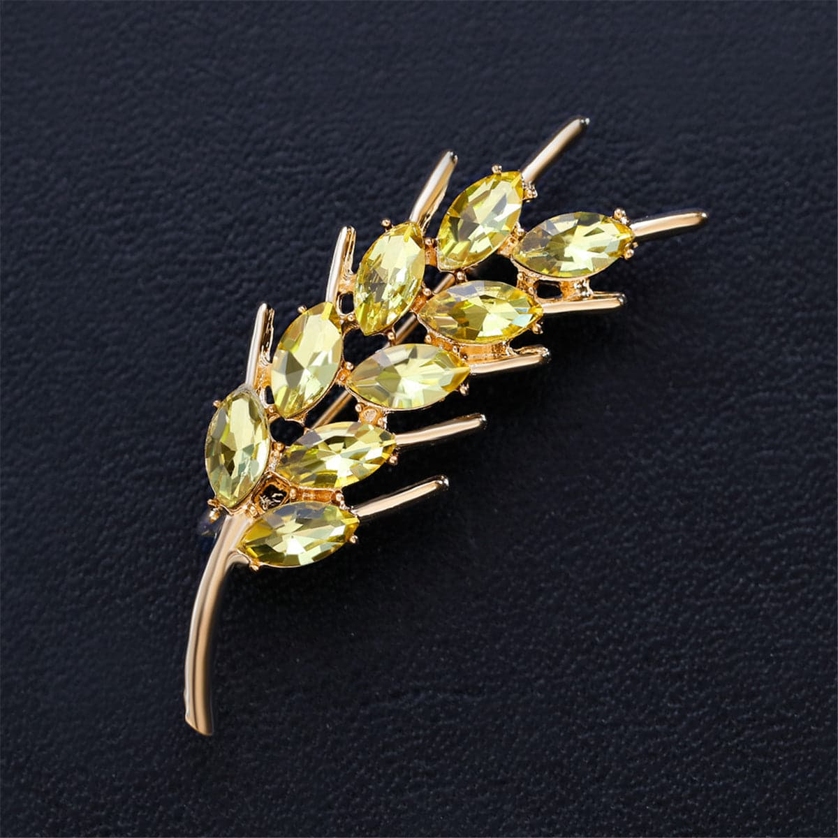 Elegant 18K gold-plated brooch featuring stunning green stones, designed in a beautiful wheat motif.