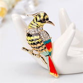 A stunning 18K gold-plated bird brooch adorned with vibrant colors and sparkling cubic zirconia accents.