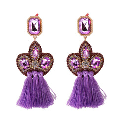 Stunning purple tassel earrings crafted from gold and purple crystals, showcasing a chic fringe drop design with cubic zirconia.