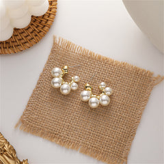 Stunning pearl cluster earrings with 18K gold-plated C-shape huggies, perfect for adding elegance to any outfit.