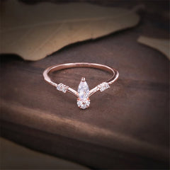 A chic marquise-cut diamond ring in rose gold, beautifully adorned with cubic zirconia for added brilliance.