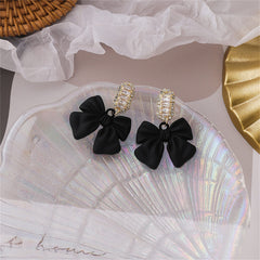 Chic black acrylic drop earrings shaped like bows, embellished with shimmering cubic zirconia for added glamour.