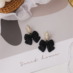 Stunning black bowknot earrings with crystal accents, showcasing a modern drop style and eye-catching design.