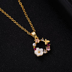 Stunning gold-plated necklace with delicate pink flowers and sparkling crystals, ideal for any special occasion.